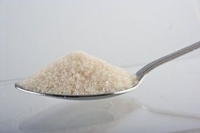 sweet white sugar on a spoon