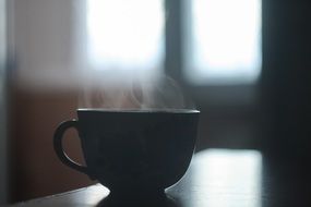 black cup with hot coffee