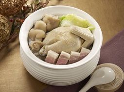 dish with chicken in a white pot