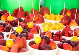 white bowls with colorful fruit salad