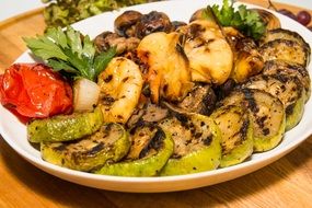 grilled vegetables with herbs on a plate in a restaurant