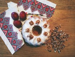 cake with nuts and easter eggs on an embroidered towel