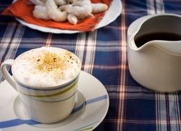 cup of cappuccino with cinnamon on the table for breakfast