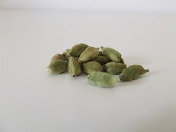 green kardanom seeds at grey surface