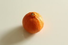 Mandarin fruit on a white surface