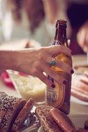 bottle in woman's hand and bread