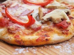 lush pizza with mushrooms and tomatoes
