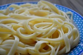 pasta with butter on a blue plate