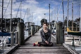 girl on the pier among the yachts
