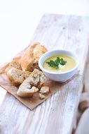 bowl of soup with bread on the table