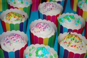 muffins with white fondant and colored sprinkles