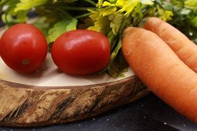 vegetables and herbs on a wooden board