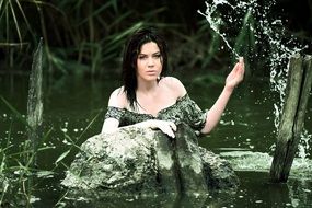 young woman splashing around in the pond