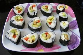 japan rolls on a plate with a floral print