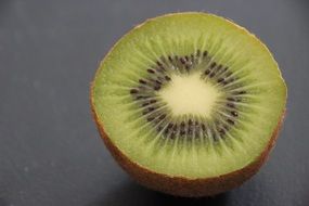 half of kiwi on a gray background