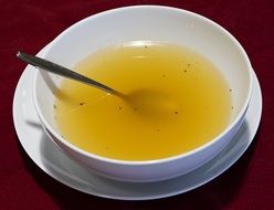 Clear chicken Broth in white Bowl