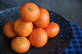 tangerines pile on a plate