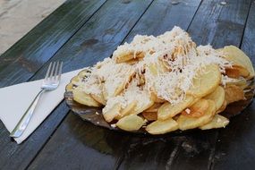 fried potatoes sprinkled with cheese