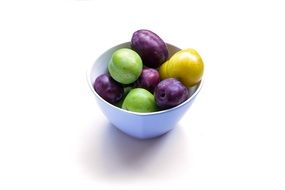 Colorful plums in a plate