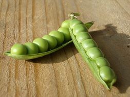 pods with green peas on the table