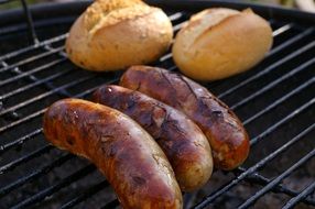 sausages and bread on grill as barbeque