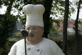 sculpture of a cook on the street
