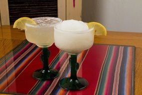 two-drink Margarita with a lemon on the table
