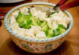 Salad with Mozzarella and Cucumber in bowl