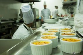 Chef and cooks are making desserts in the restaurant