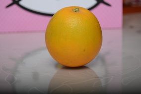 orange lies on a glass table