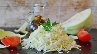 pile of cut White Cabbage and Herbs on table