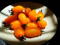 Small orange tomatoes in the light and shadow