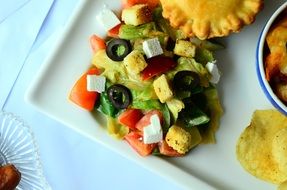 salad, pie and chips on a plate