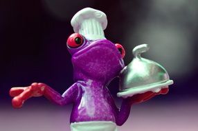 figure of a purple frog cook close-up on blurred background