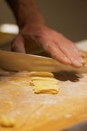 Cutting while cooking Pasta on table