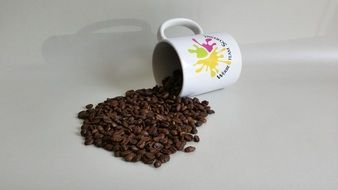 Coffee beans are dropping from the cup