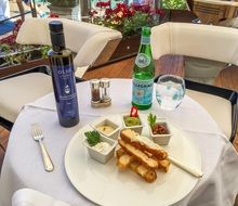 Olive Oil in bottle and vegetarian food on lable in cafe