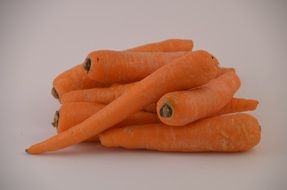 washed carrots on a white table