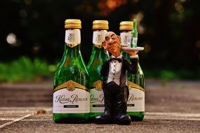 Waiter with tray figurine and wine bottles