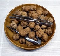 Walnuts and nutcrackers in bowl