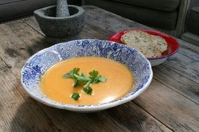 orange pumpkin soup in a blue plate