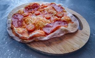 Homemade Pizza on a wooden cutting board