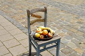 summer fruits in a bowl on a chair