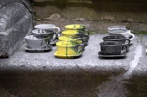 multi-colored ceramic cups and saucers