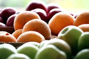 appetizing Apple and Peaches close-up on blurred background