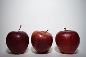 three ripe shiny apples