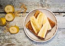 toast with bananas on a wooden surface