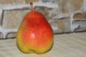 yellow-red pear on the kitchen table