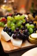 black and green grapes on the table