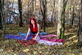 picture of red haired Girl in sunny Forest at Autumn